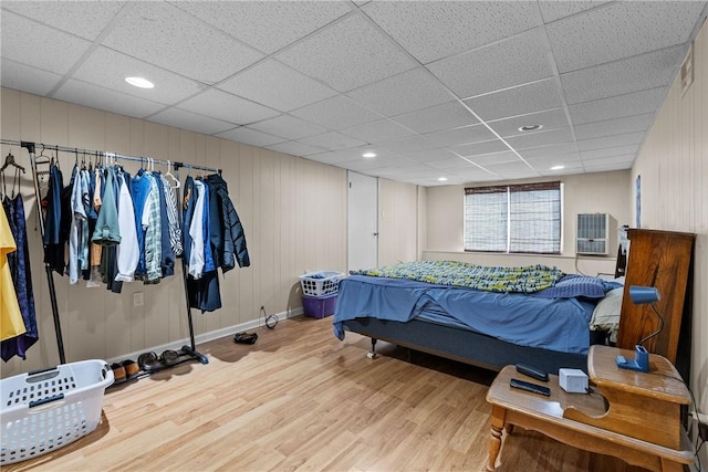 bedroom featuring wood-type flooring and a paneled ceiling