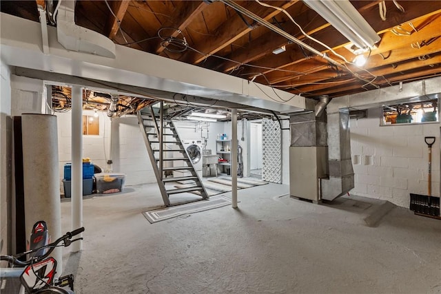 basement with washer / clothes dryer and heating unit