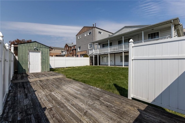 deck with a shed and a yard