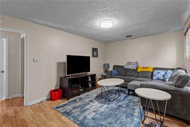 living room with light hardwood / wood-style flooring and a textured ceiling