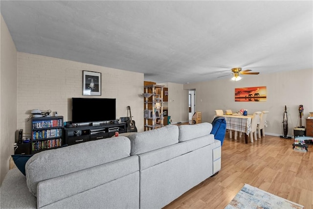 living room featuring ceiling fan and light wood-type flooring