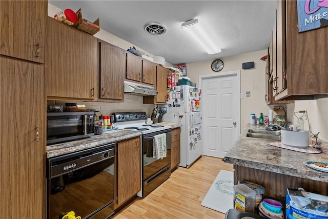 kitchen featuring sink, electric range, black dishwasher, white refrigerator, and light hardwood / wood-style floors