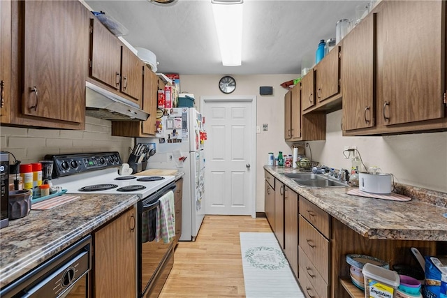 kitchen with range with electric stovetop, dishwasher, sink, backsplash, and light hardwood / wood-style flooring