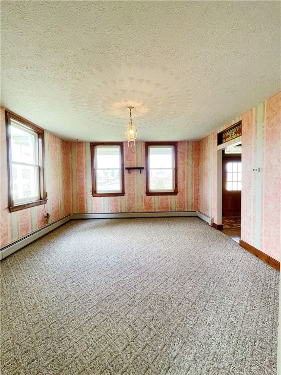 carpeted empty room featuring a textured ceiling