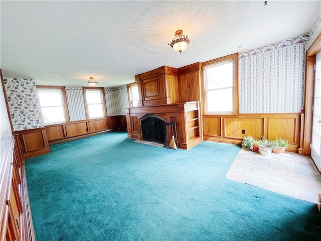 interior space with a large fireplace, carpet flooring, and a textured ceiling