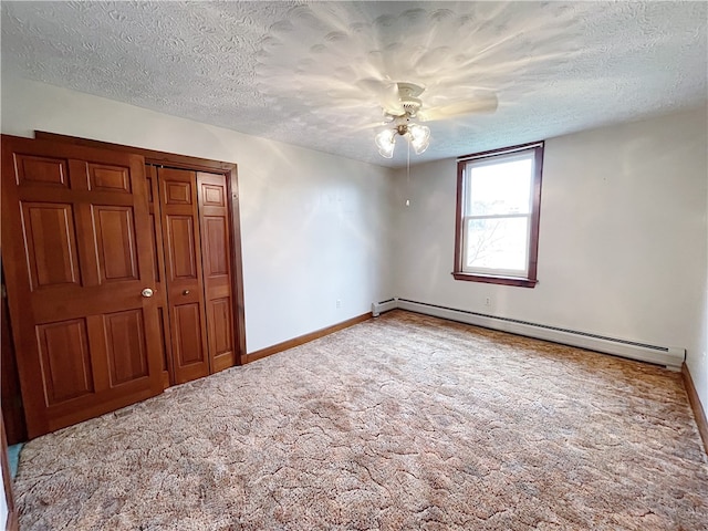 unfurnished bedroom with carpet, a baseboard radiator, ceiling fan, and a textured ceiling