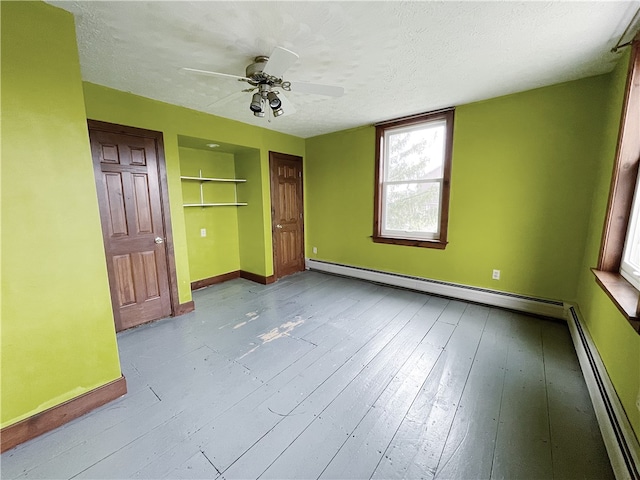 unfurnished bedroom with a baseboard radiator, a textured ceiling, ceiling fan, and light hardwood / wood-style flooring