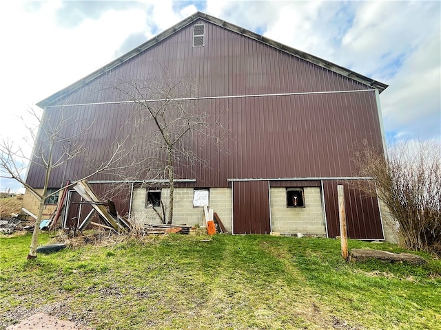 rear view of property featuring a yard