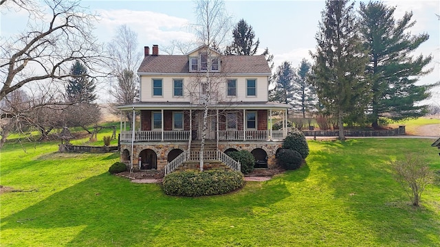 back of house with a porch and a yard