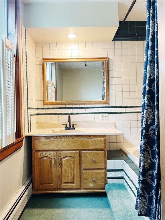 bathroom featuring vanity, a baseboard heating unit, and tile walls