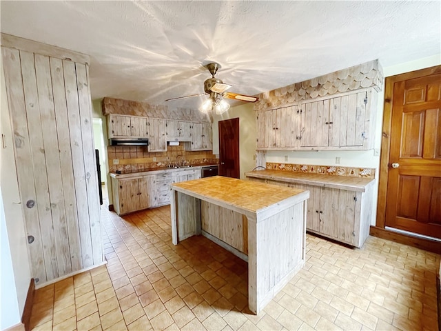 kitchen with light brown cabinetry, a kitchen island, light tile flooring, and ceiling fan