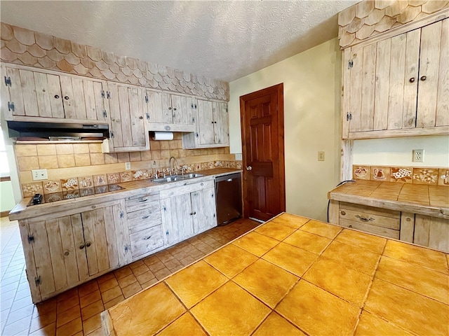 kitchen featuring stainless steel dishwasher, light tile floors, tile countertops, a textured ceiling, and sink