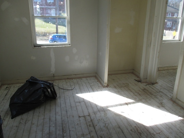 unfurnished room with light wood-type flooring