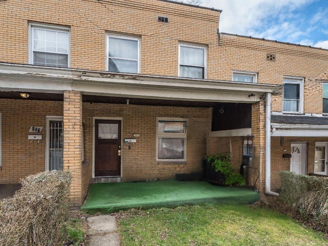 doorway to property featuring a yard