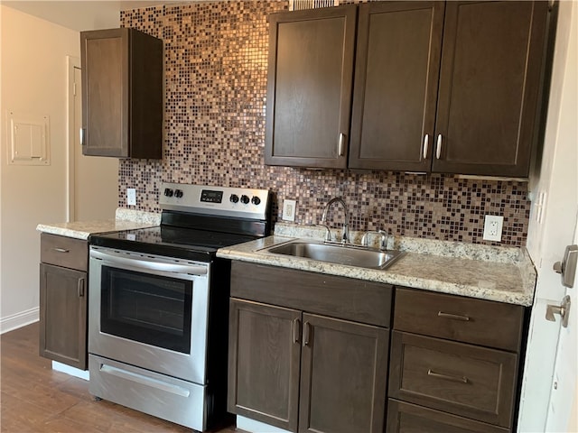 kitchen with sink, stainless steel electric range oven, tasteful backsplash, and dark brown cabinetry