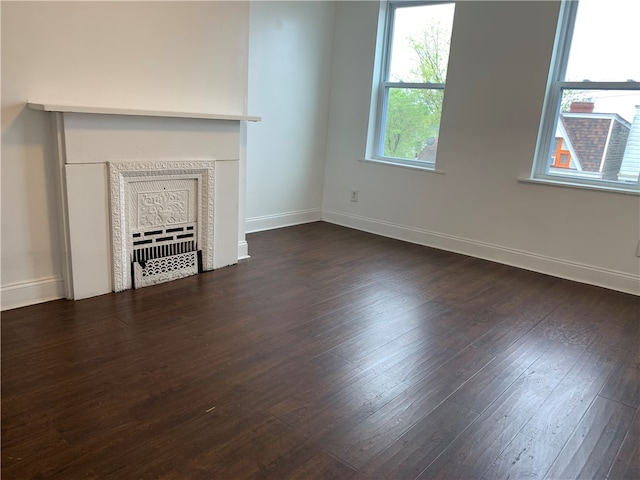 unfurnished living room with dark hardwood / wood-style floors and a fireplace