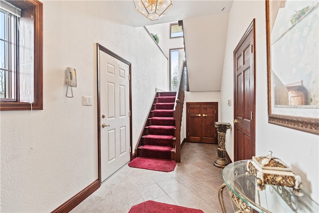 foyer entrance featuring light tile patterned flooring