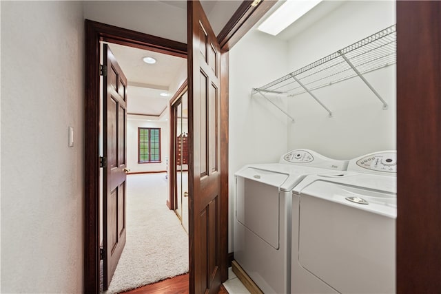 laundry room with independent washer and dryer and carpet flooring