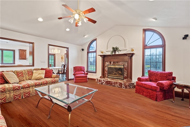 living room with lofted ceiling, wood-type flooring, a healthy amount of sunlight, and ceiling fan