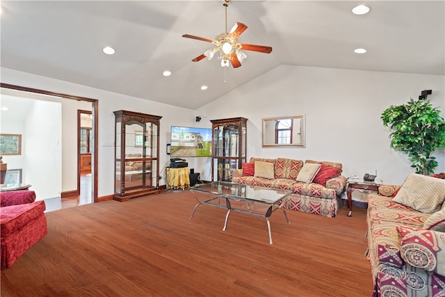 living room with wood-type flooring, vaulted ceiling, and ceiling fan