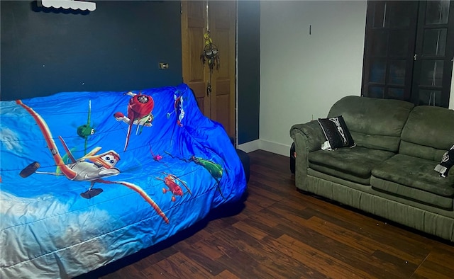 bedroom with dark hardwood / wood-style floors