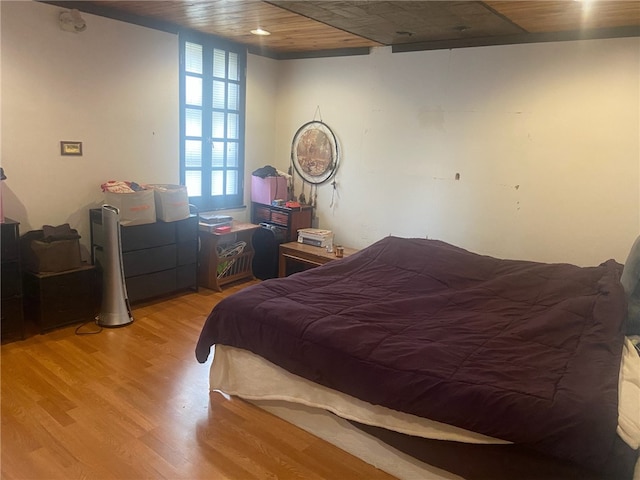 bedroom featuring light hardwood / wood-style floors and wooden ceiling