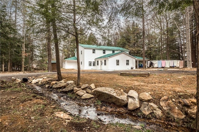 view of front of home featuring a water view, a garage, and an outdoor structure