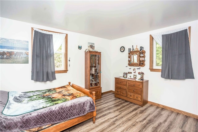 bedroom with hardwood / wood-style flooring