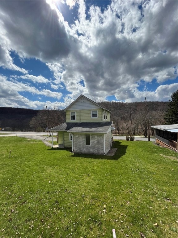 view of side of home with a lawn