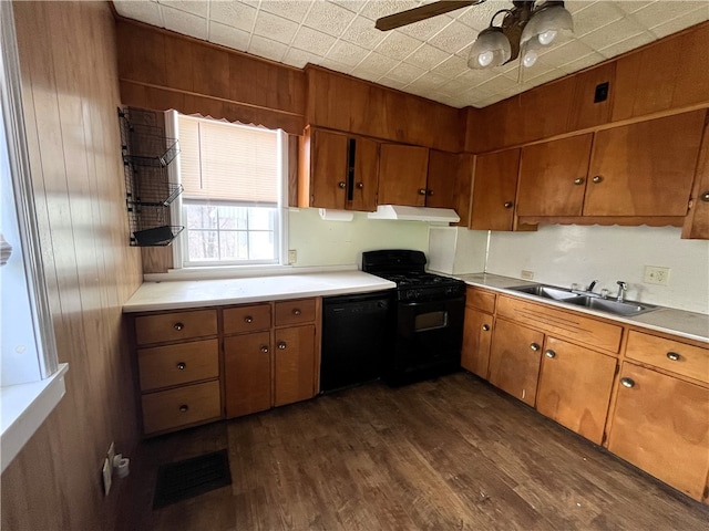 kitchen featuring dark hardwood / wood-style flooring, ceiling fan, black appliances, and sink