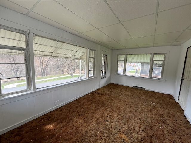 spare room with a paneled ceiling