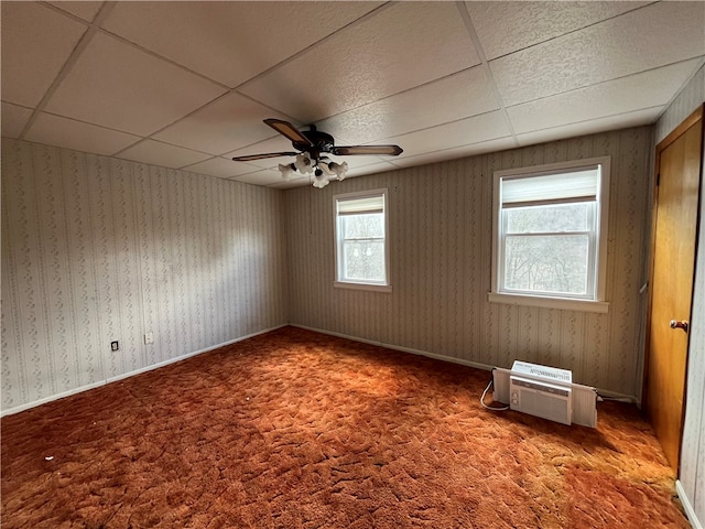 carpeted spare room featuring ceiling fan and a paneled ceiling