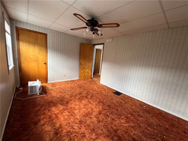 unfurnished bedroom with carpet, ceiling fan, and a drop ceiling