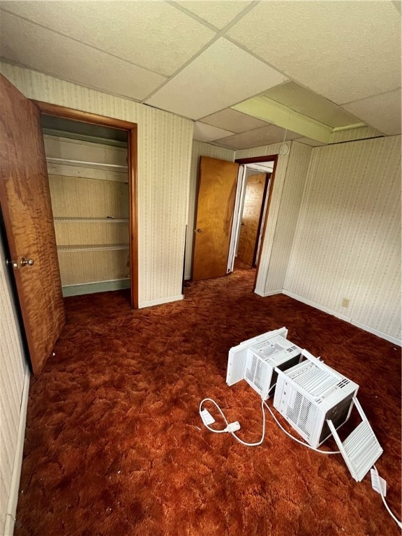 unfurnished bedroom with a closet and a drop ceiling