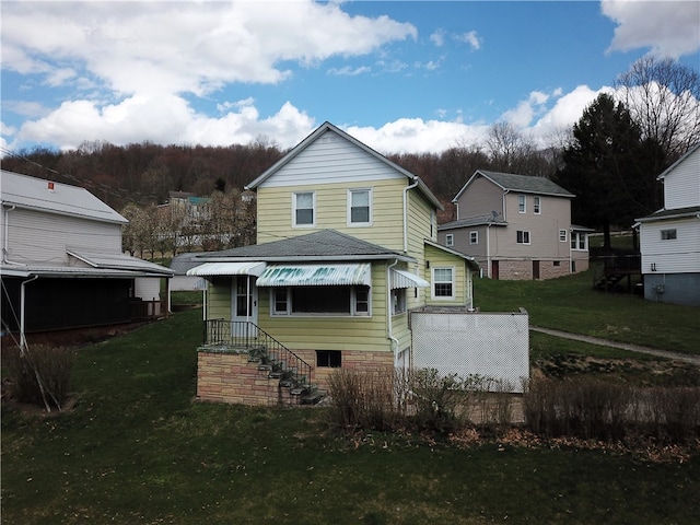 back of house with a lawn