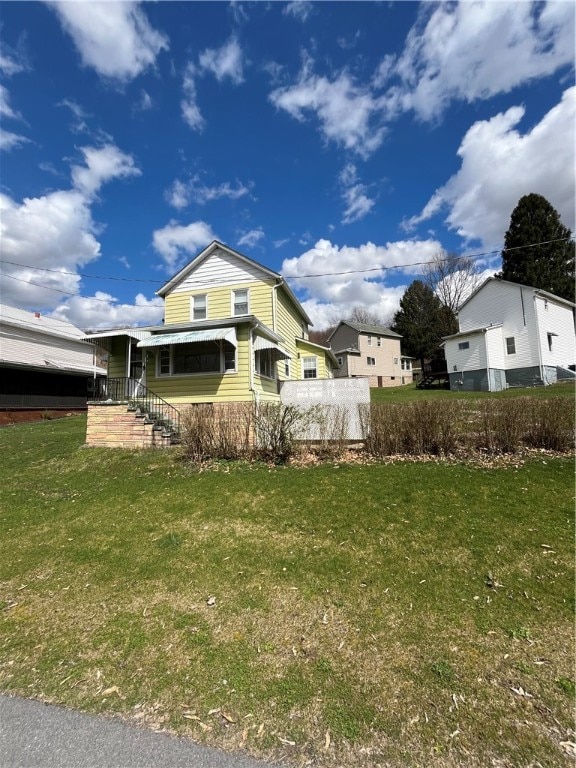 rear view of property with a lawn