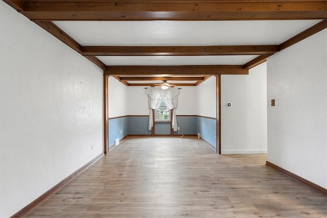 unfurnished room featuring beam ceiling and light hardwood / wood-style flooring