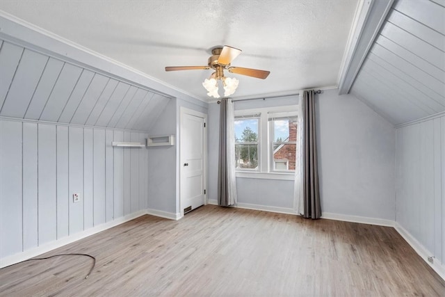 bonus room featuring ceiling fan, light wood-type flooring, and vaulted ceiling