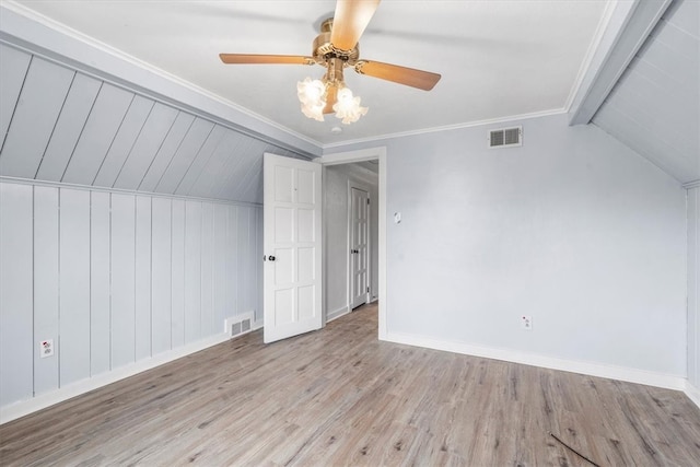 additional living space with ceiling fan, light wood-type flooring, and vaulted ceiling