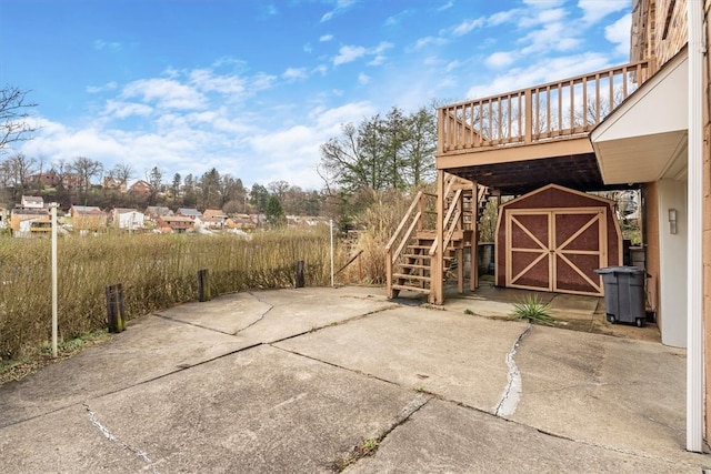 view of patio / terrace with a storage shed and a deck