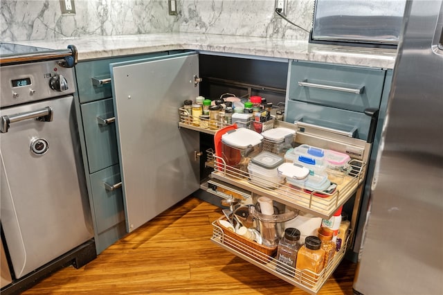 interior space with range, stainless steel refrigerator, and light wood-type flooring