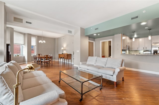 living room featuring a notable chandelier and hardwood / wood-style flooring