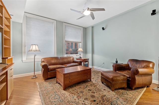 living room with ceiling fan and light wood-type flooring