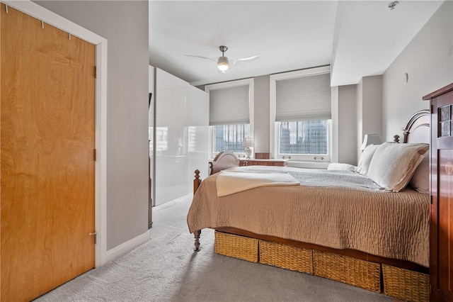 bedroom with ceiling fan and light colored carpet