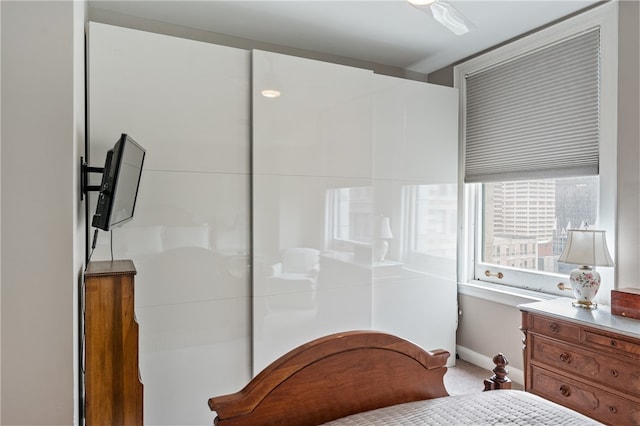 bedroom featuring light colored carpet and ceiling fan