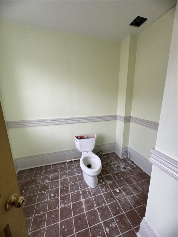 bathroom with tile flooring and toilet