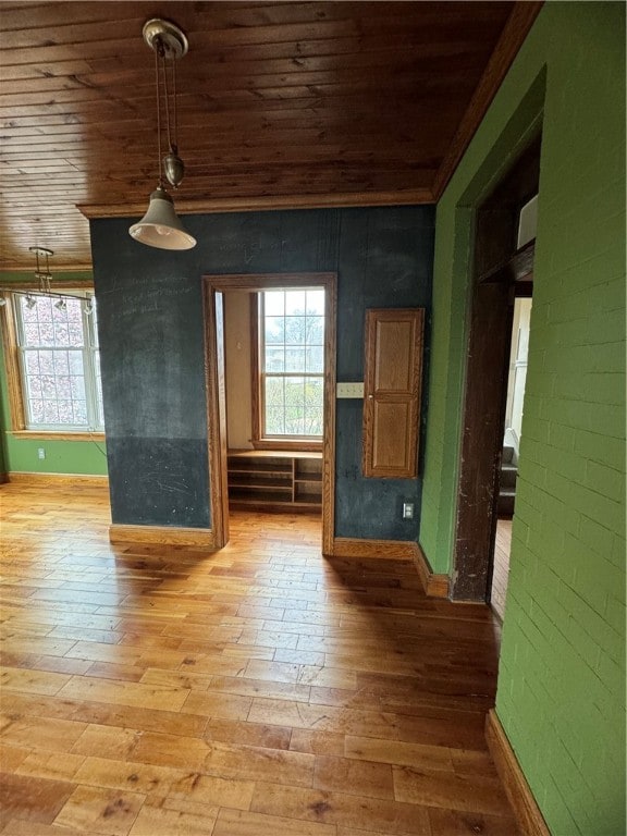 unfurnished living room featuring light hardwood / wood-style flooring and wood ceiling