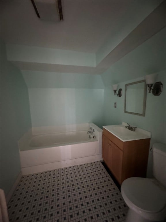 bathroom featuring toilet, vanity with extensive cabinet space, tile floors, and a bath to relax in