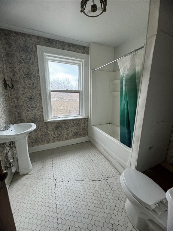 bathroom featuring shower / bath combo with shower curtain, toilet, and tile floors