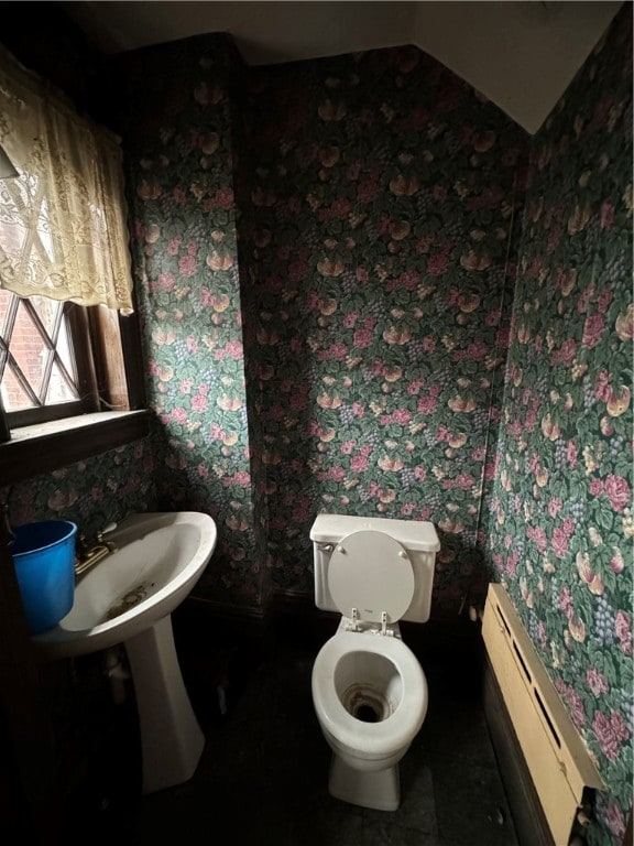 bathroom with toilet and a baseboard heating unit